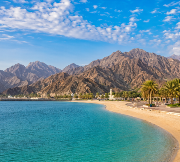 Best Places To Visit In Khor Fakkan - Scenic Mountain & Coastal Views Panoramic view of Khor Fakkan coastline with Hajar Mountains, turquoise water and scenic tourist attractions on UAE east coast
