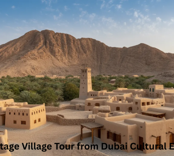 Hatta Heritage Village Tour Dubai - Traditional Mountain Village Experience Traditional stone houses and historic watchtower at Hatta Heritage Village Dubai with Hajar Mountains backdrop