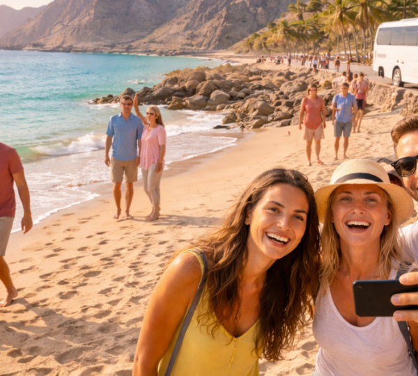 Khor Fakkan Group Tour Highlights - Mountain Views & Beach Stops Group enjoying mountain viewpoints and beach activities on a Khor Fakkan group sightseeing tour
