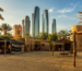 A photorealistic view of Heritage Village Abu Dhabi showcasing traditional Emirati architecture and cultural heritage, representing the experience of a Abu Dhabi Heritage Village Private Tour with Zutours.