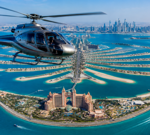 Helicopter flying over Palm Jumeirah with Atlantis resort and turquoise waters below