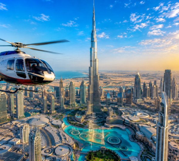 Helicopter flying over Dubai skyline with Burj Khalifa and Downtown Dubai towers